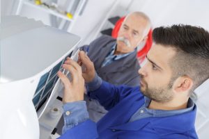 man repairing a DICOM CD burner